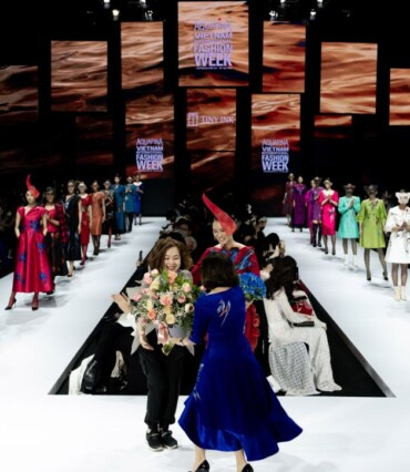 Finale of a fashion week runway with designers and full cast
