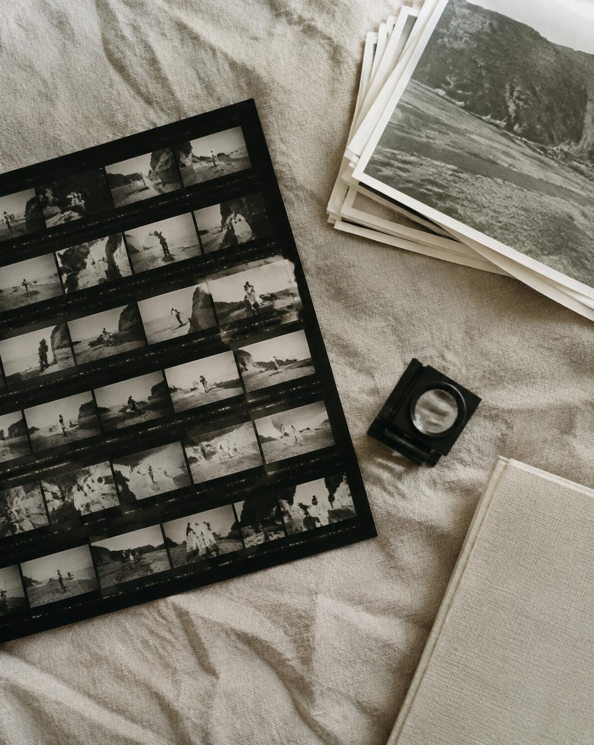 Contact sheets and a loupe on linen