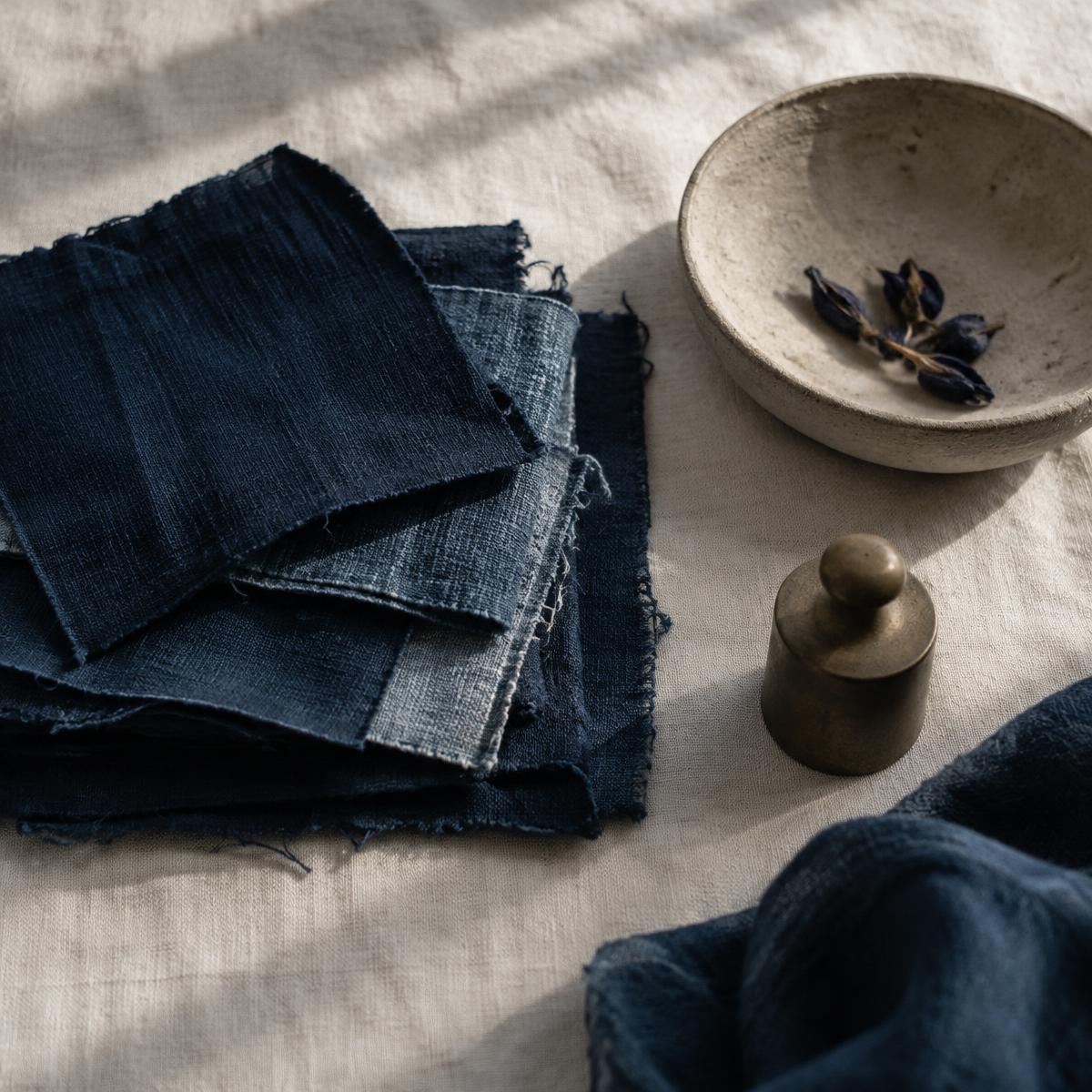 Indigo, brass and unglazed clay — the palette of provenance.